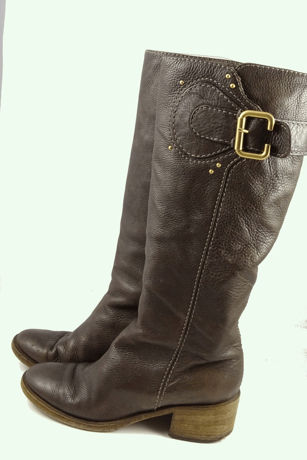 Genuine leather knee high boot with buckle detail on calf. Has signs of wear. Top of boot measure 33cm.