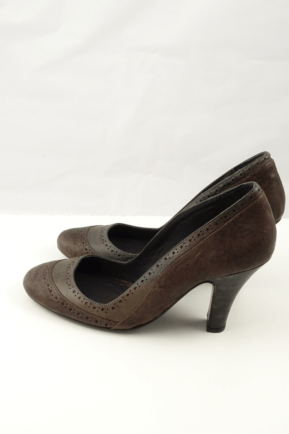 Genuine leather pumps with mixed tone brown and cut out detail around edge.