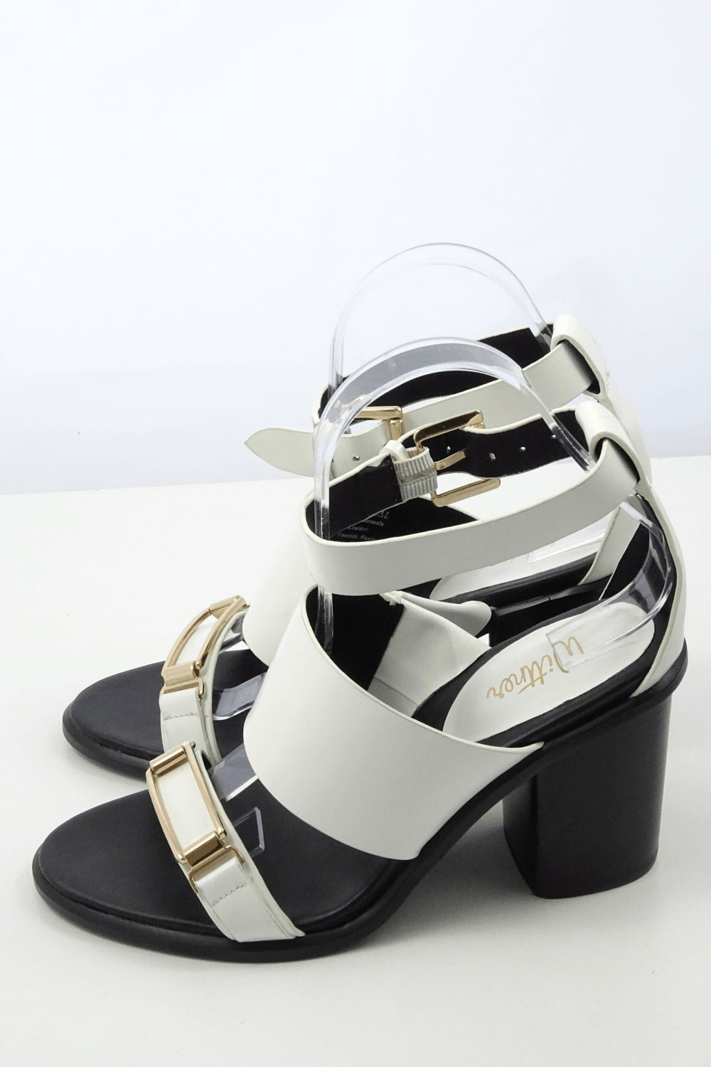 Black and white sandals with gold buckle detail. New without tags.