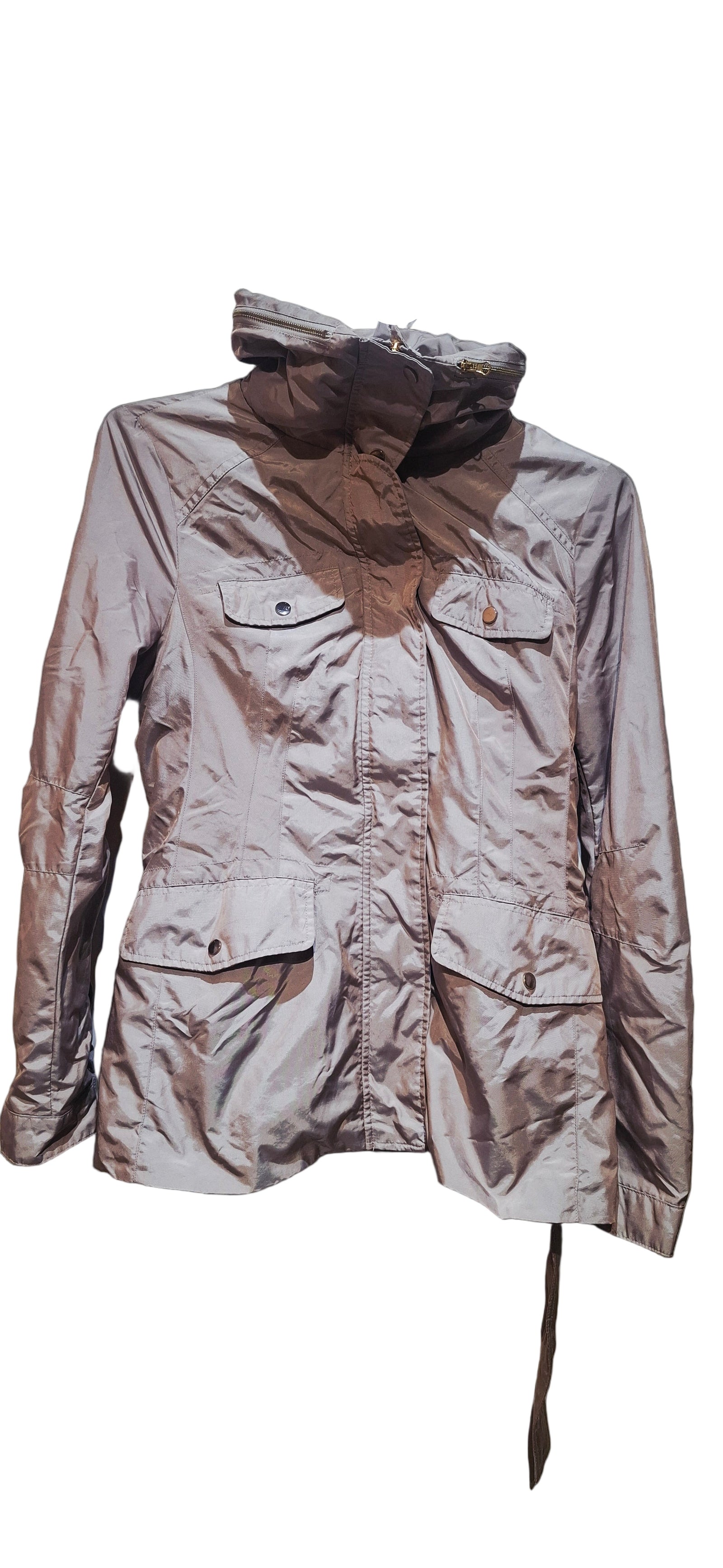 Light-colored jacket with a brown collar on a hanger against a dark background